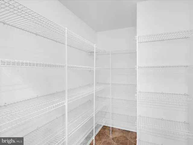 an empty room with window and a ceiling fan