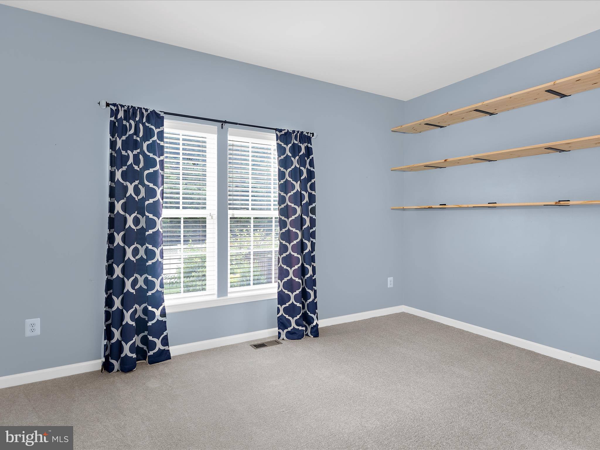 103 Adela Way Chestertown, MD 21620 - Photo 32 of 90 a view of an empty room with window plants and wooden floor
