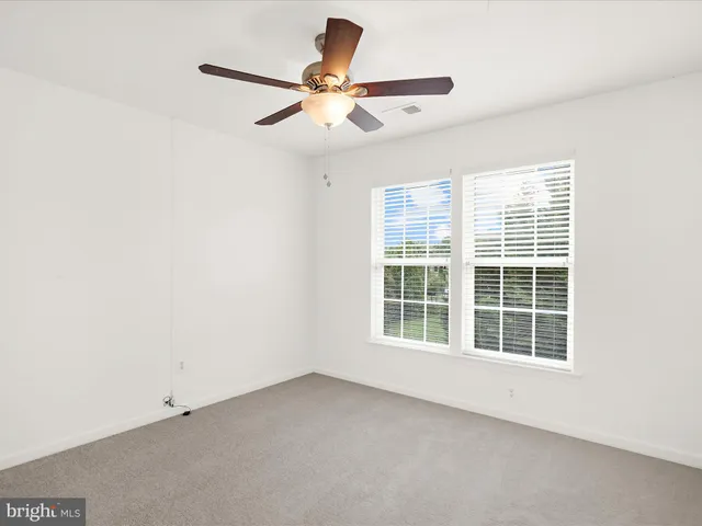 a kitchen with stainless steel appliances a stove a sink dishwasher a microwave oven and a sink with wooden cabinets