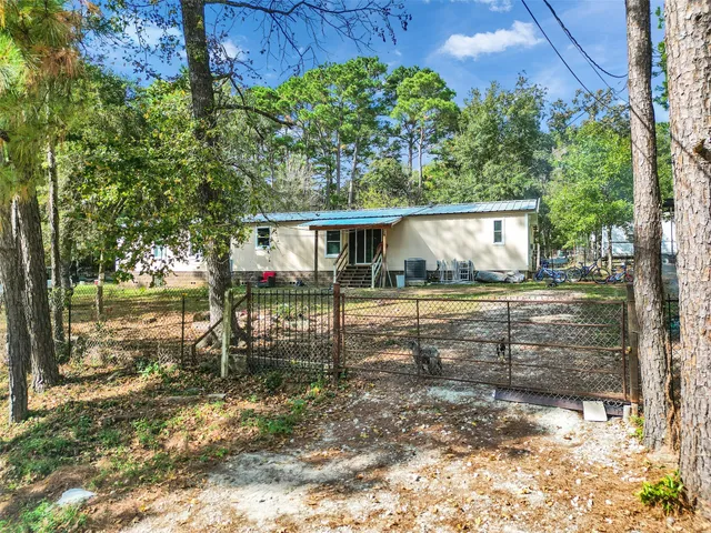 a view of house with a yard