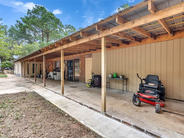 a backyard of a house with barbeque oven table and chairs
