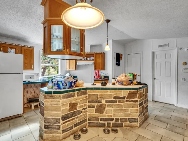 a room with furniture a chandelier and a wooden floor