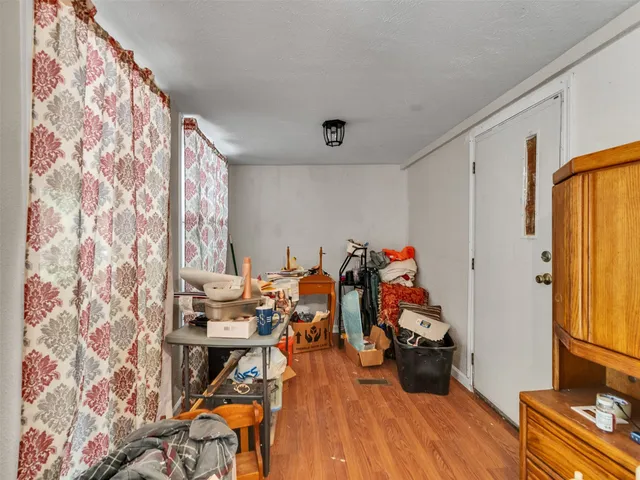 a view of a room with wooden floor and furniture