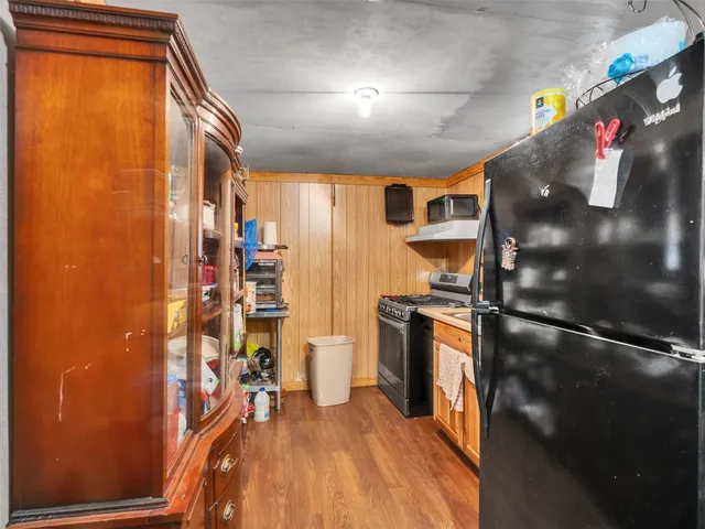 a kitchen with stainless steel appliances granite countertop a refrigerator and a stove