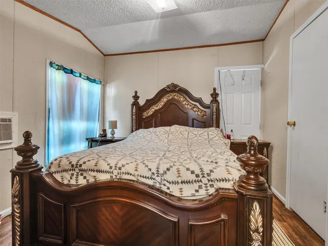 a bedroom with a bed and dresser