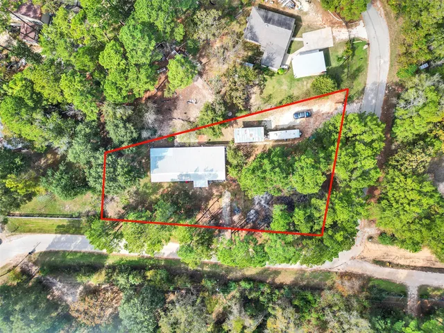 a green field with flowers and trees