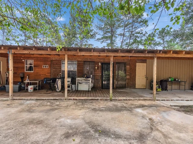 a view of a house with backyard porch and furniture
