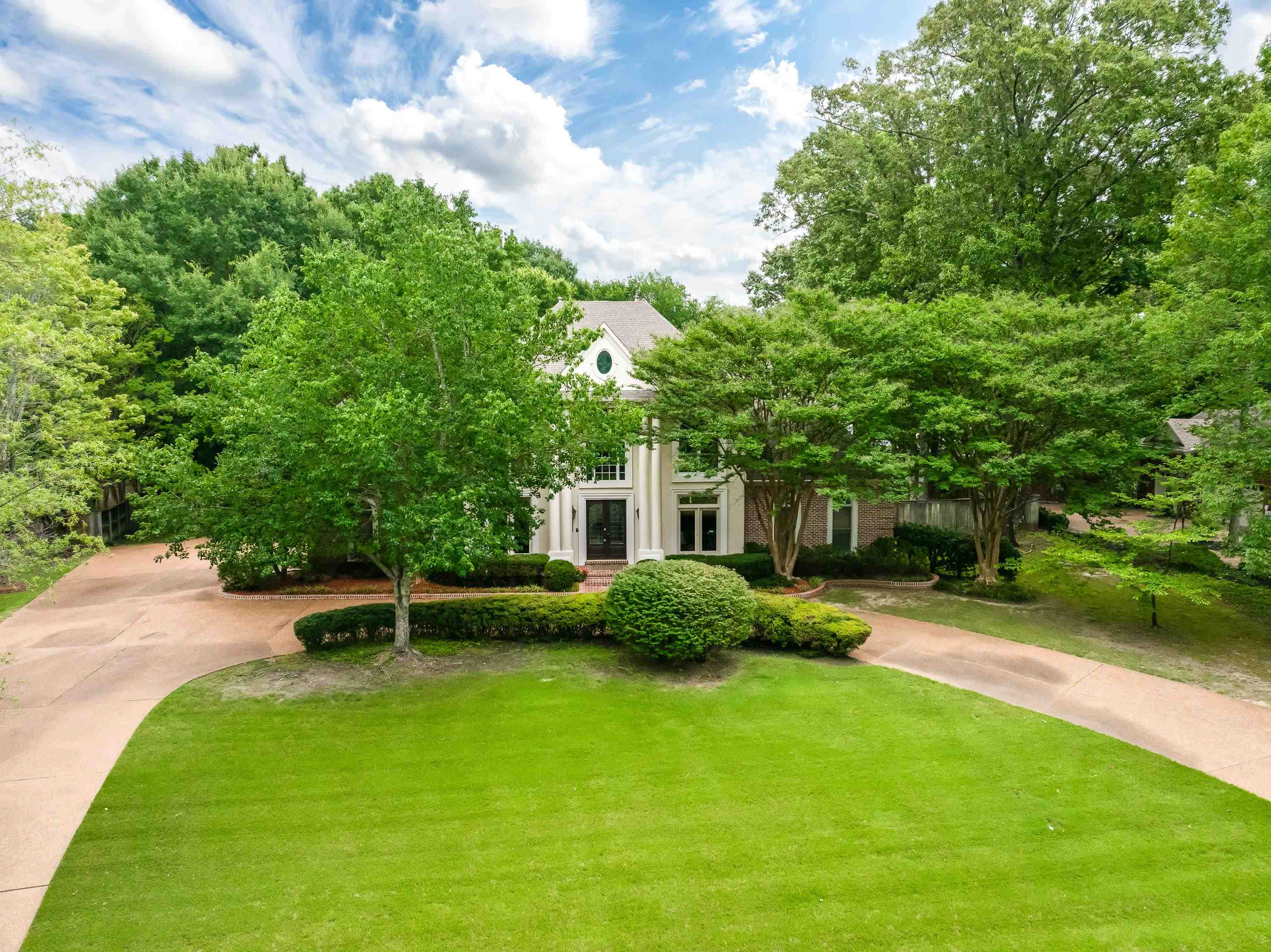 350 Bluff Ridge Cove Memphis, TN 38018 - Photo 2 of 37 Traditional-style residence with a circular drive, mature trees, and a verdant lawn