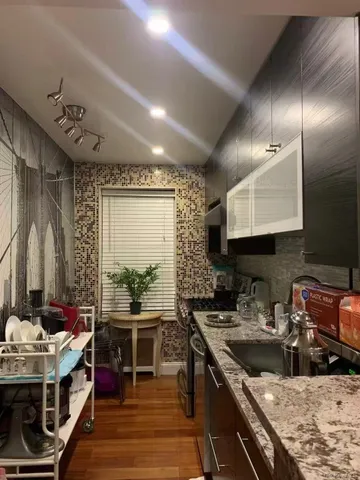 a kitchen with sink stove and cabinets