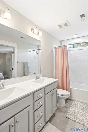a bathroom with a sink a toilet a mirror a bathtub and shower