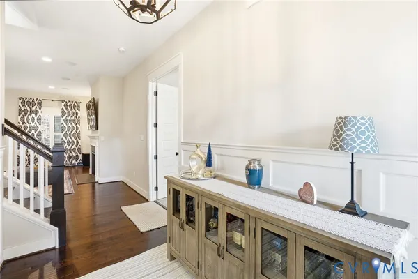a kitchen with stainless steel appliances a white stove top oven a sink a dining table and chairs