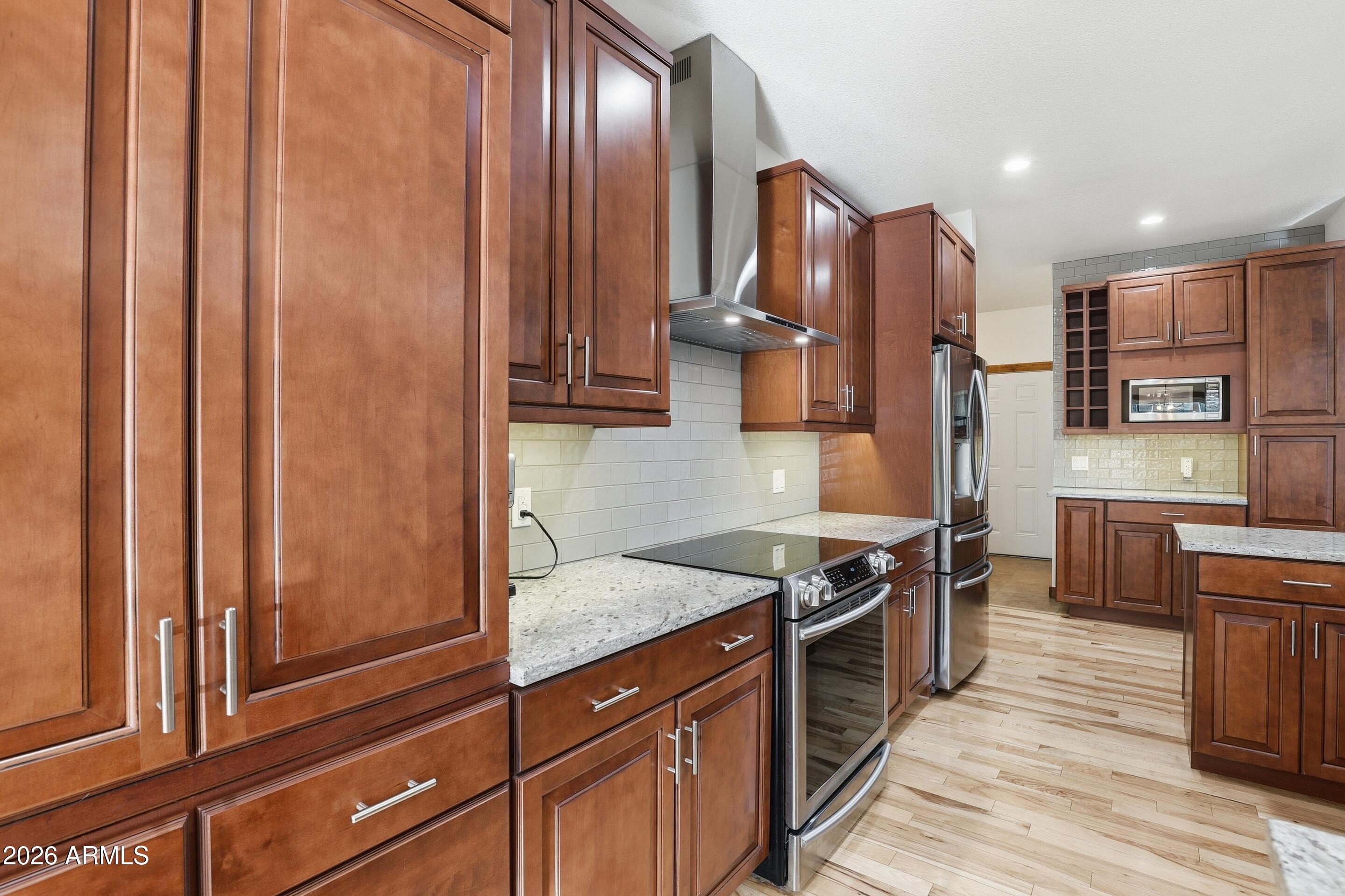 1703 West Dillon Way Payson, AZ 85541 - Photo 11 of 56 a kitchen with stainless steel appliances granite countertop wooden cabinets a refrigerator and a stove