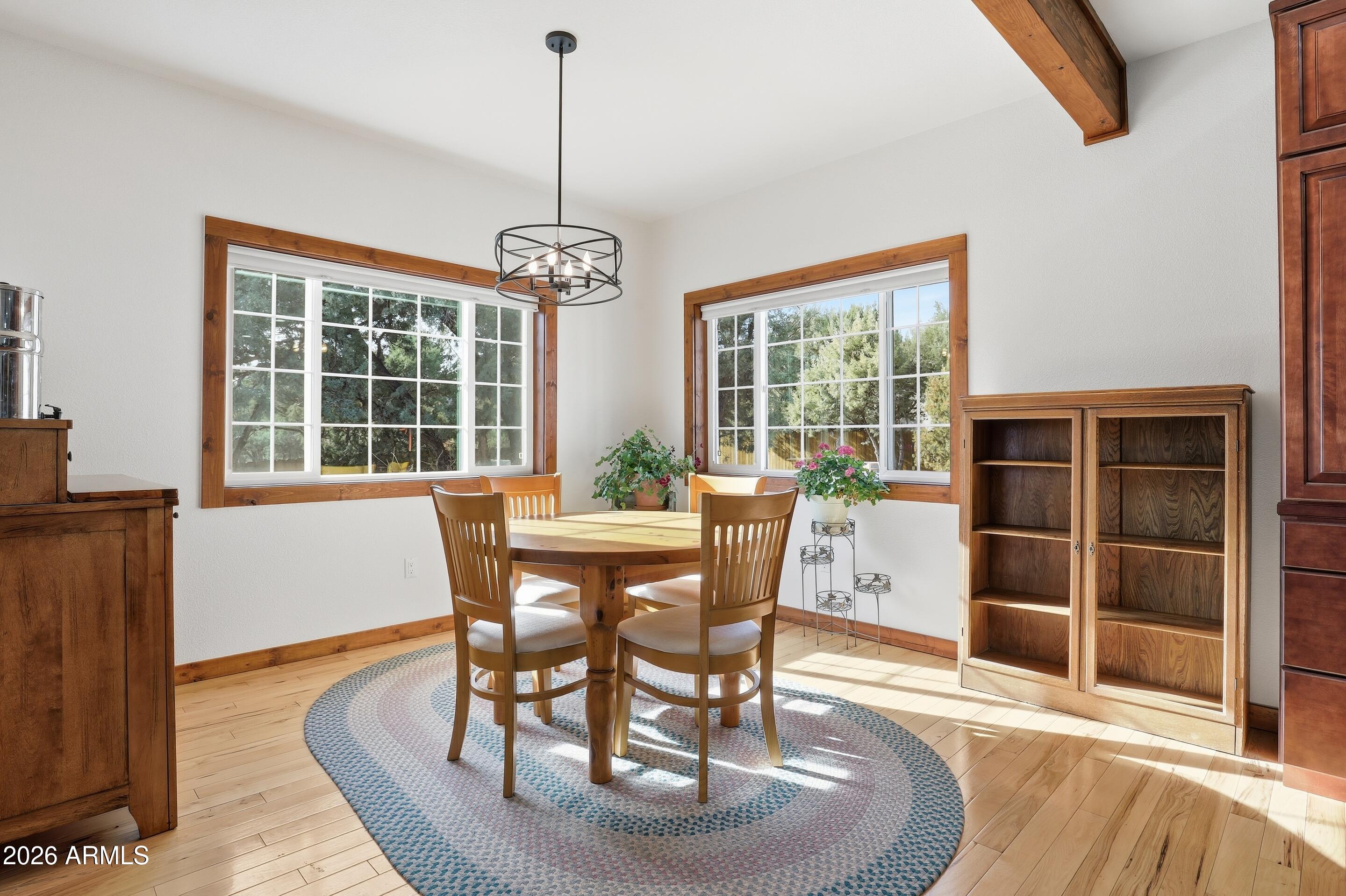 1703 West Dillon Way Payson, AZ 85541 - Photo 12 of 56 a dining room with furniture window wooden floor and a chandelier