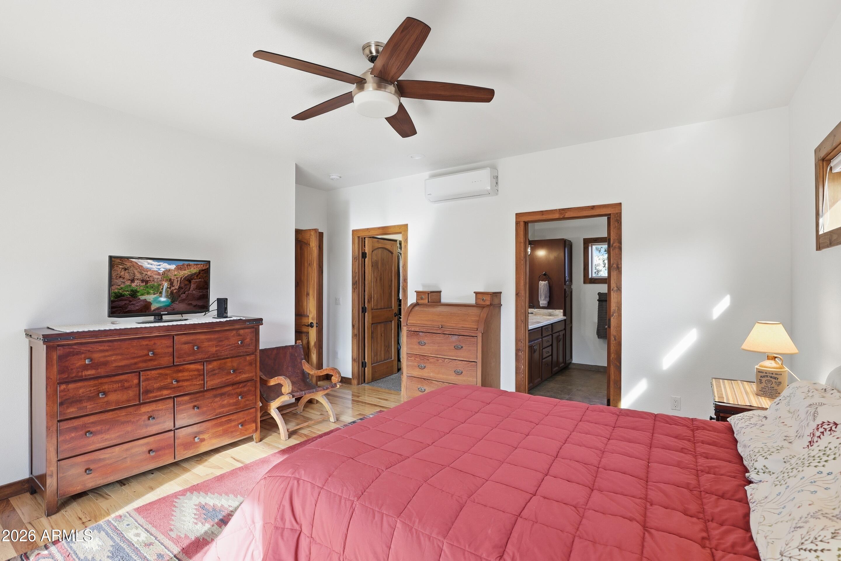 1703 West Dillon Way Payson, AZ 85541 - Photo 14 of 56 a bedroom with a bed and a chandelier