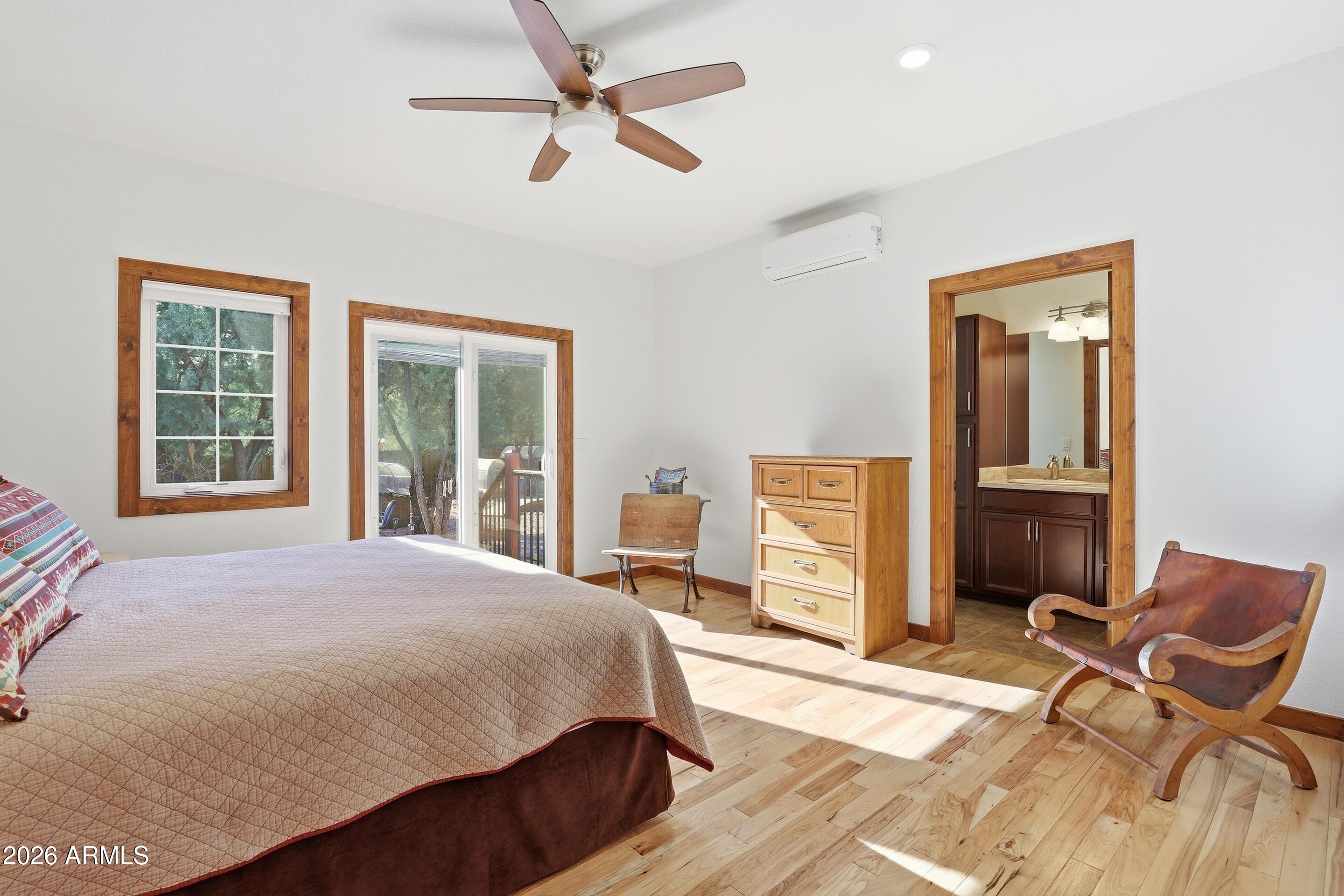 1703 West Dillon Way Payson, AZ 85541 - Photo 18 of 56 a bedroom with a bed and wooden floor