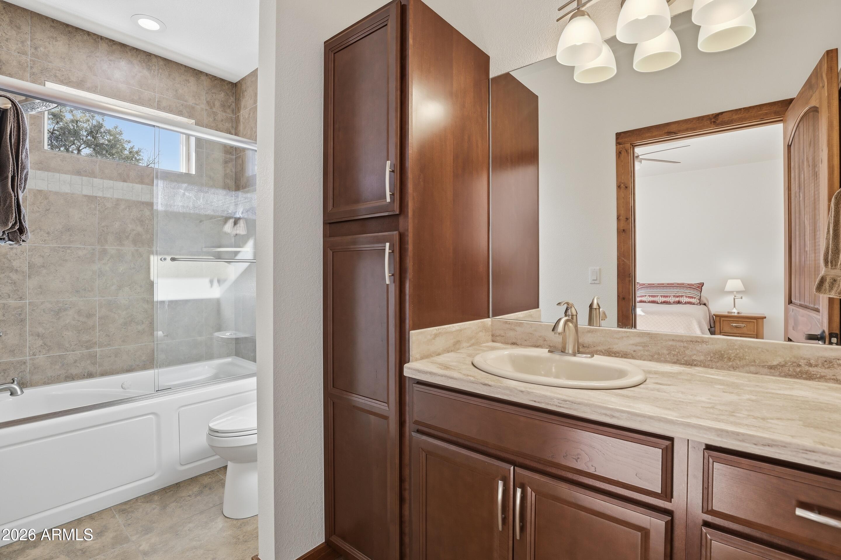 1703 West Dillon Way Payson, AZ 85541 - Photo 20 of 56 a bathroom with a sink a toilet and a large mirror