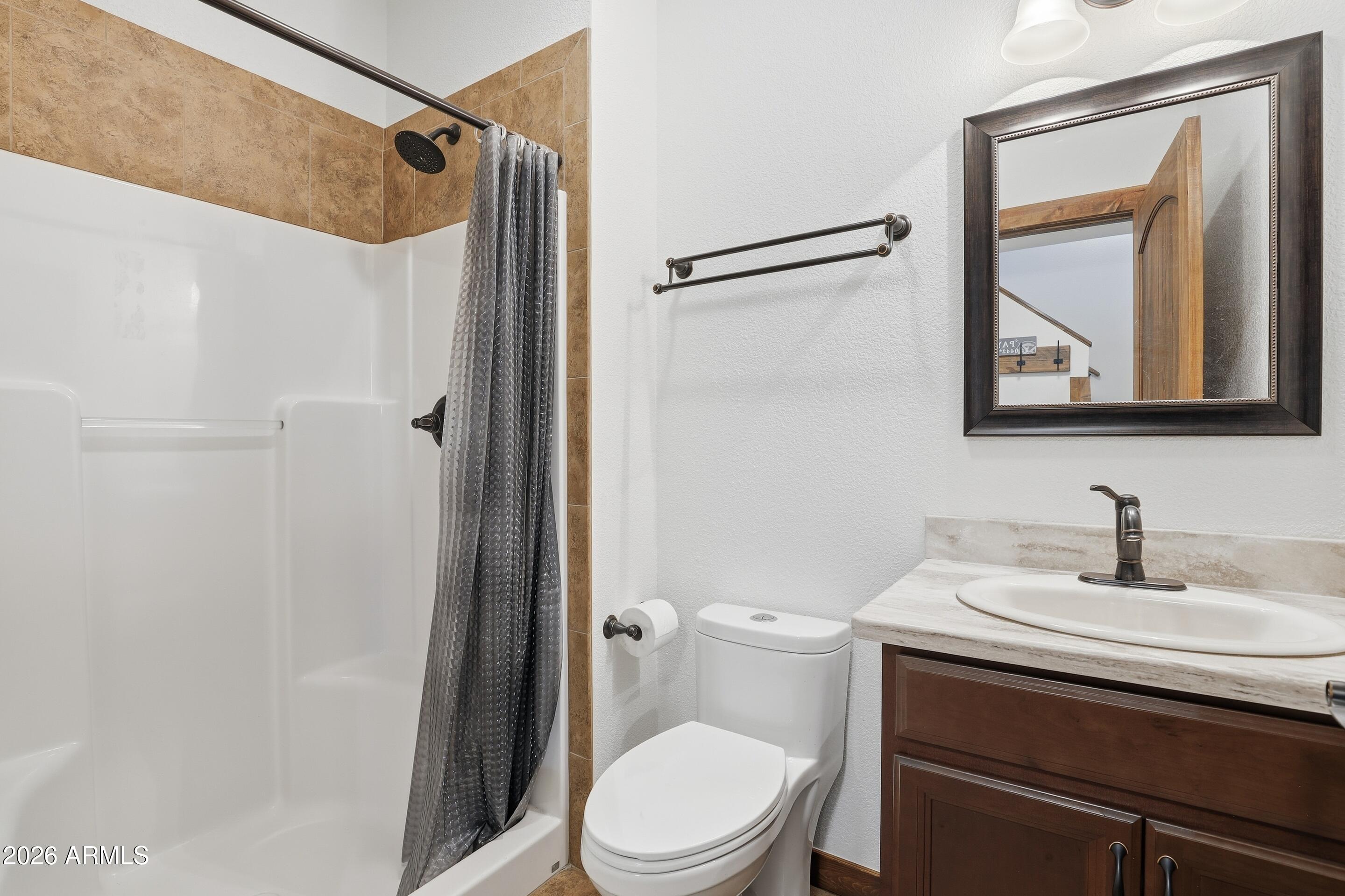 1703 West Dillon Way Payson, AZ 85541 - Photo 23 of 56 a bathroom with a sink a toilet and shower