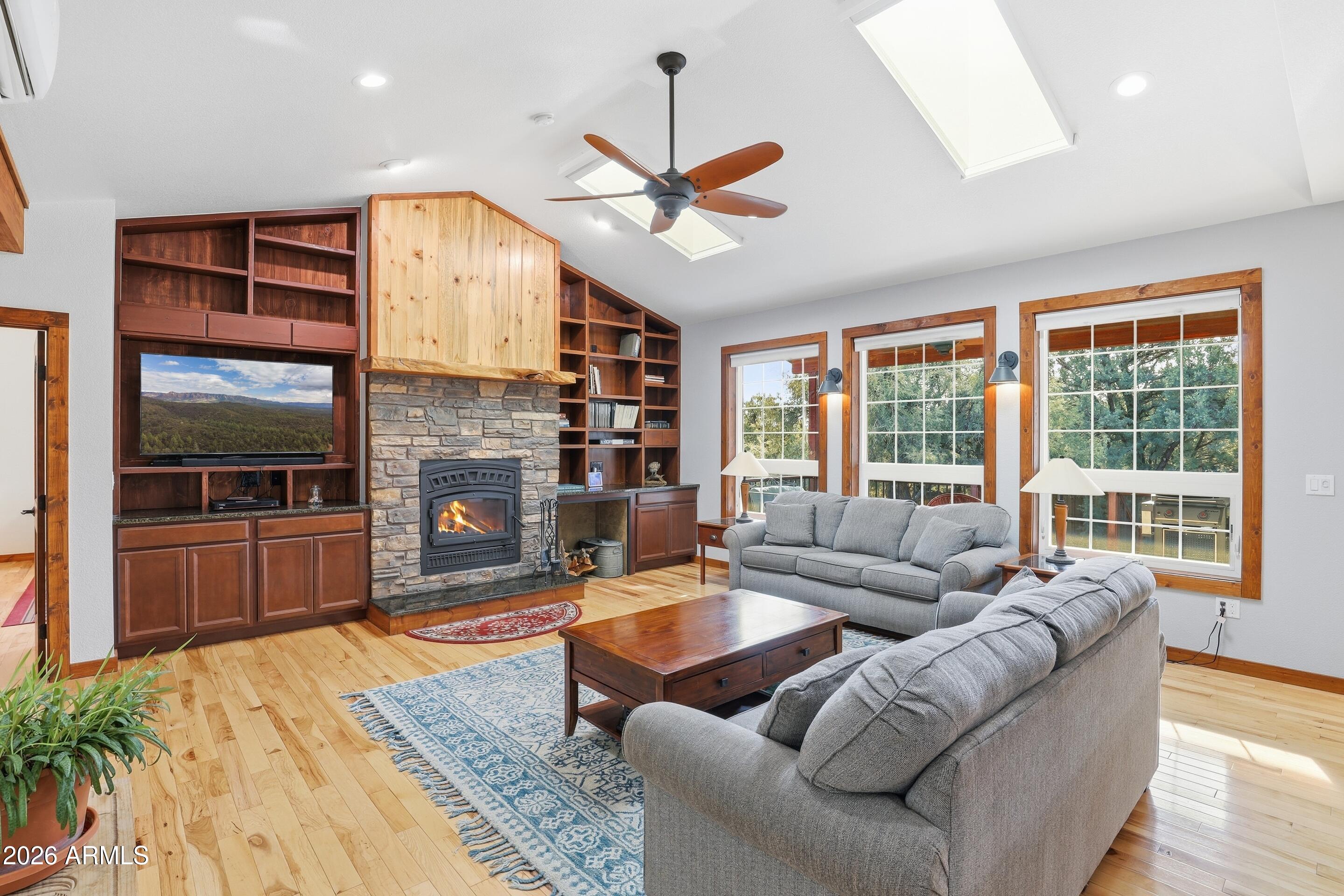 1703 West Dillon Way Payson, AZ 85541 - Photo 5 of 56 a living room with furniture a fireplace and a floor to ceiling window