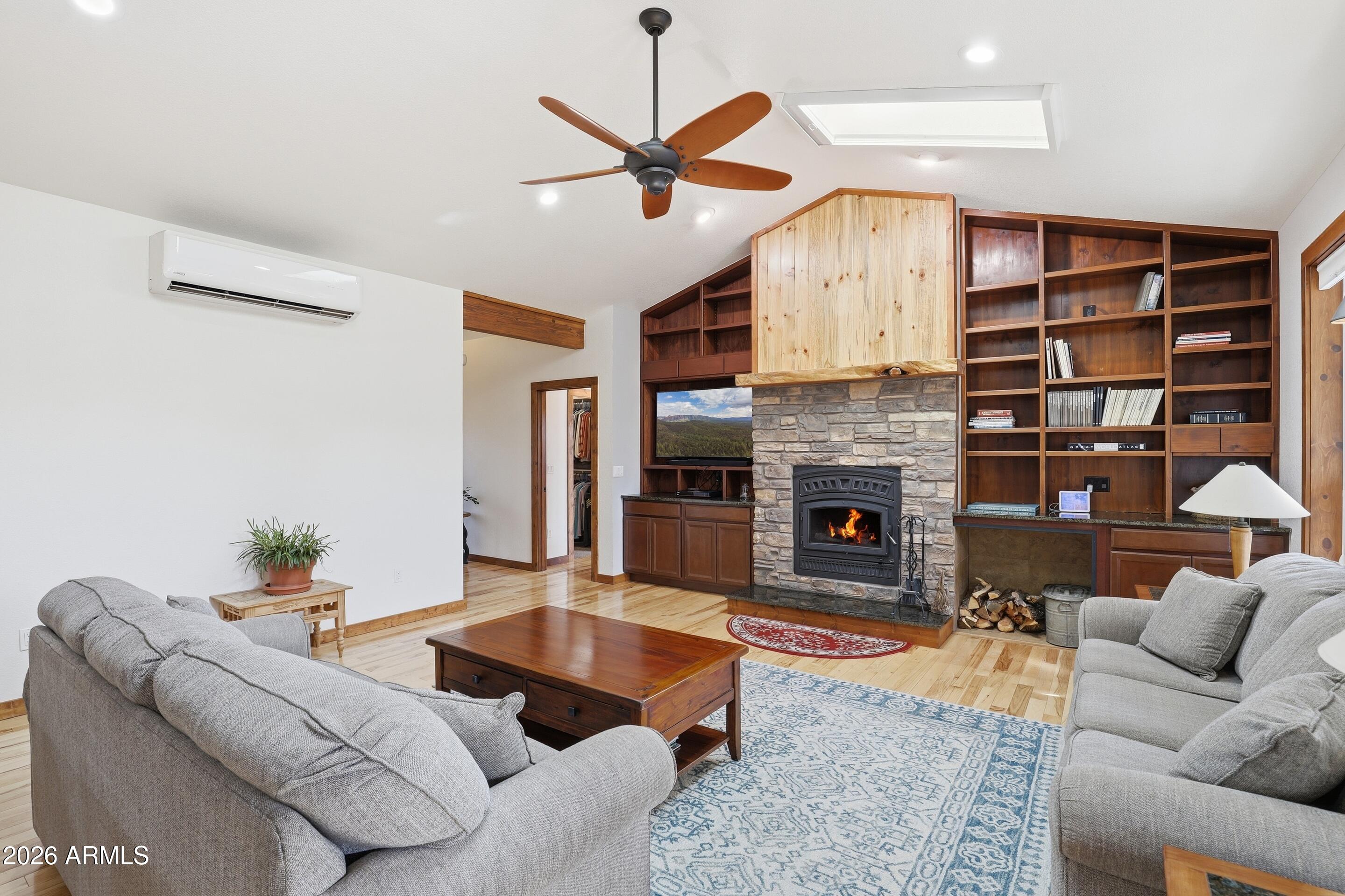 1703 West Dillon Way Payson, AZ 85541 - Photo 6 of 56 a living room with furniture a fireplace and a ceiling fan