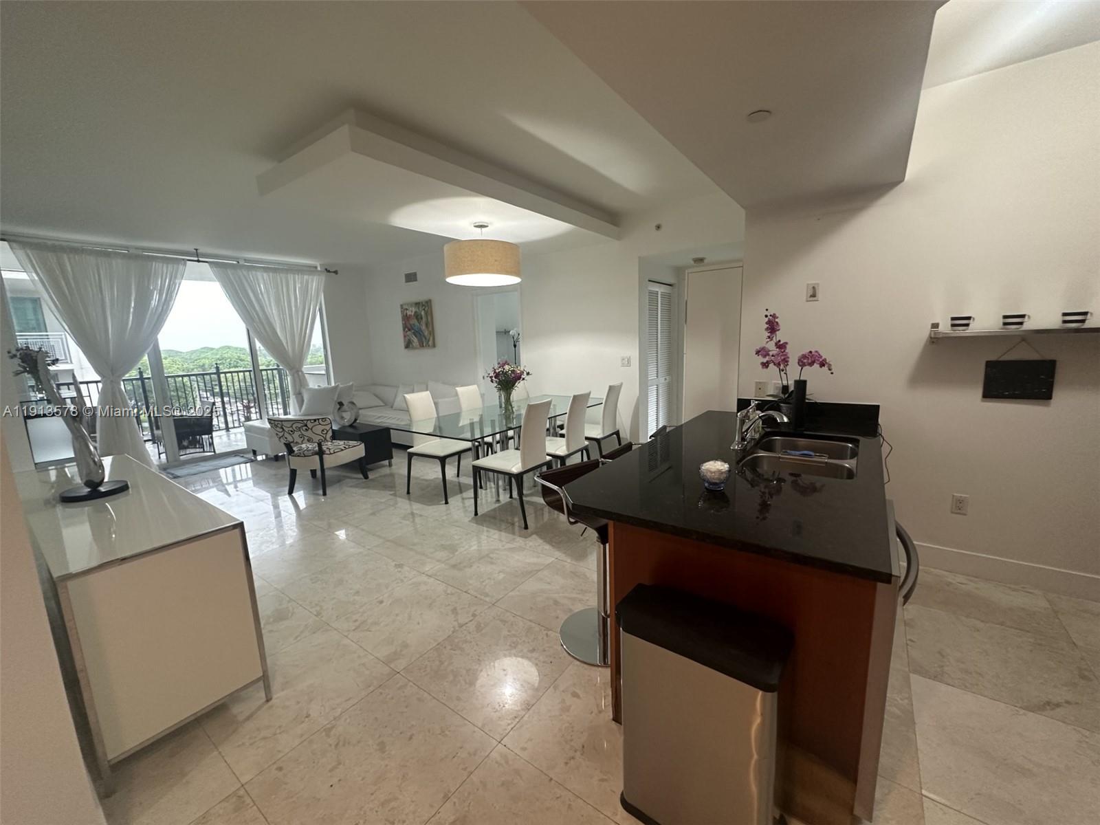 4100 Salzedo Street, Unit 704 Coral Gables, FL 33146 - Photo 11 of 25 a living room with furniture and a large window