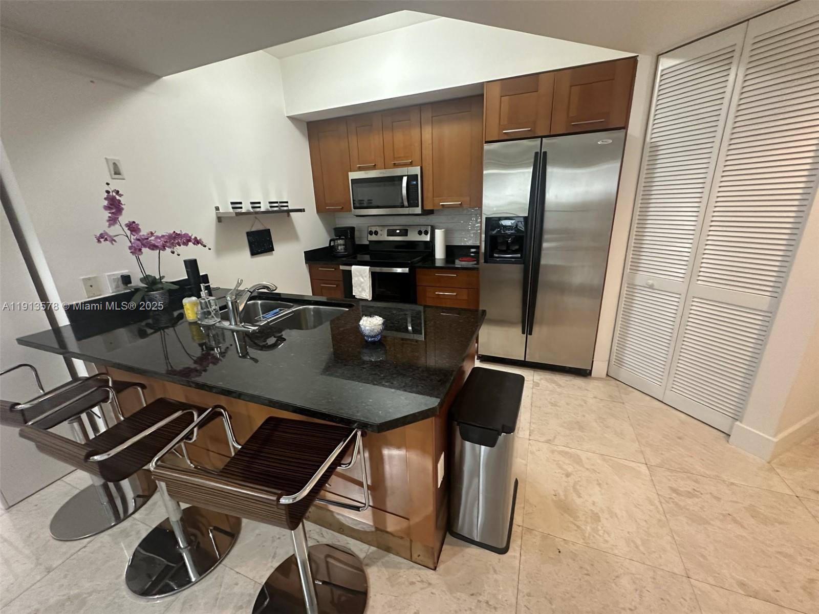 4100 Salzedo Street, Unit 704 Coral Gables, FL 33146 - Photo 13 of 25 a kitchen with a table and chairs