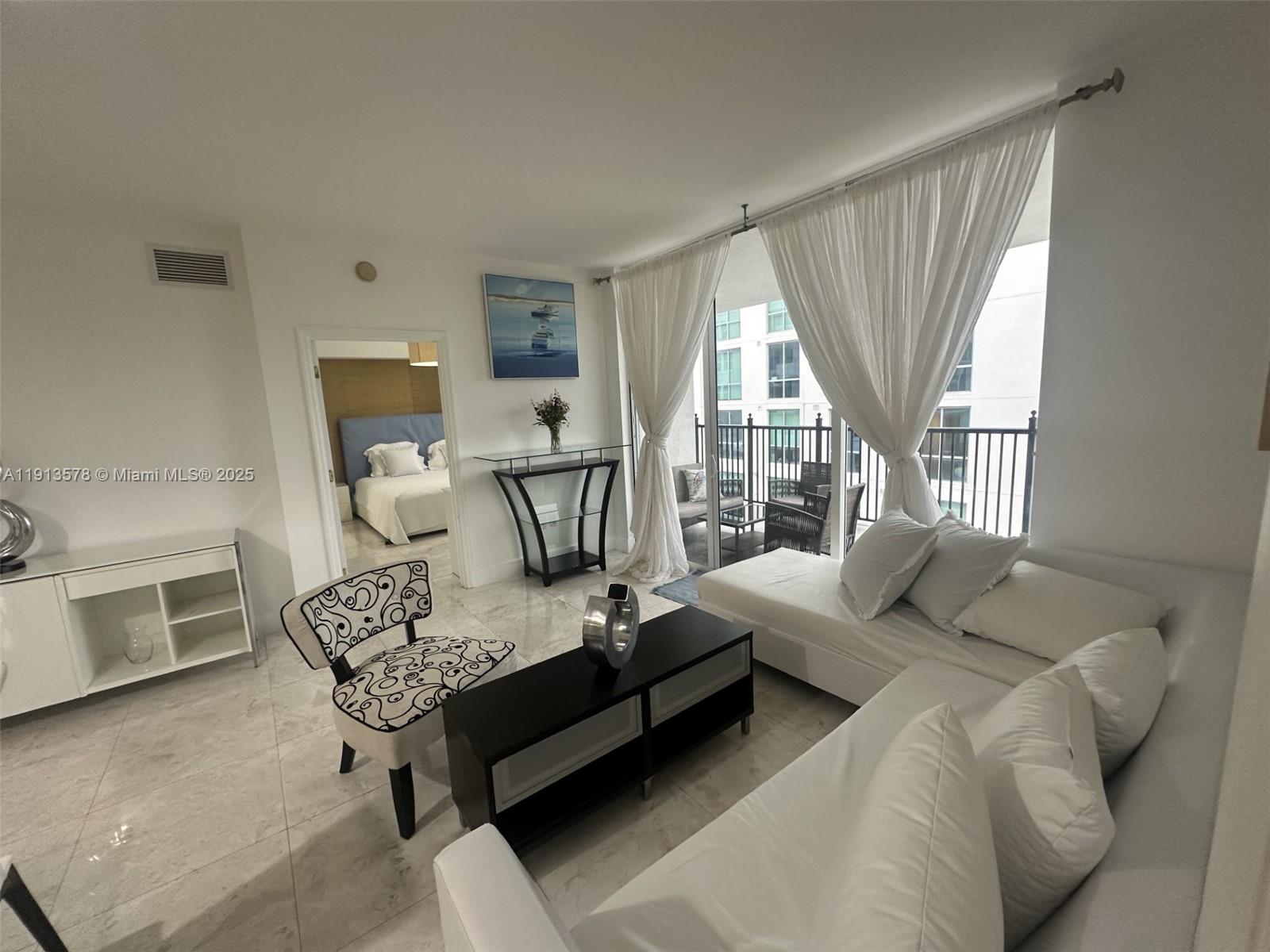 4100 Salzedo Street, Unit 704 Coral Gables, FL 33146 - Photo 15 of 25 a living room with furniture and a fireplace