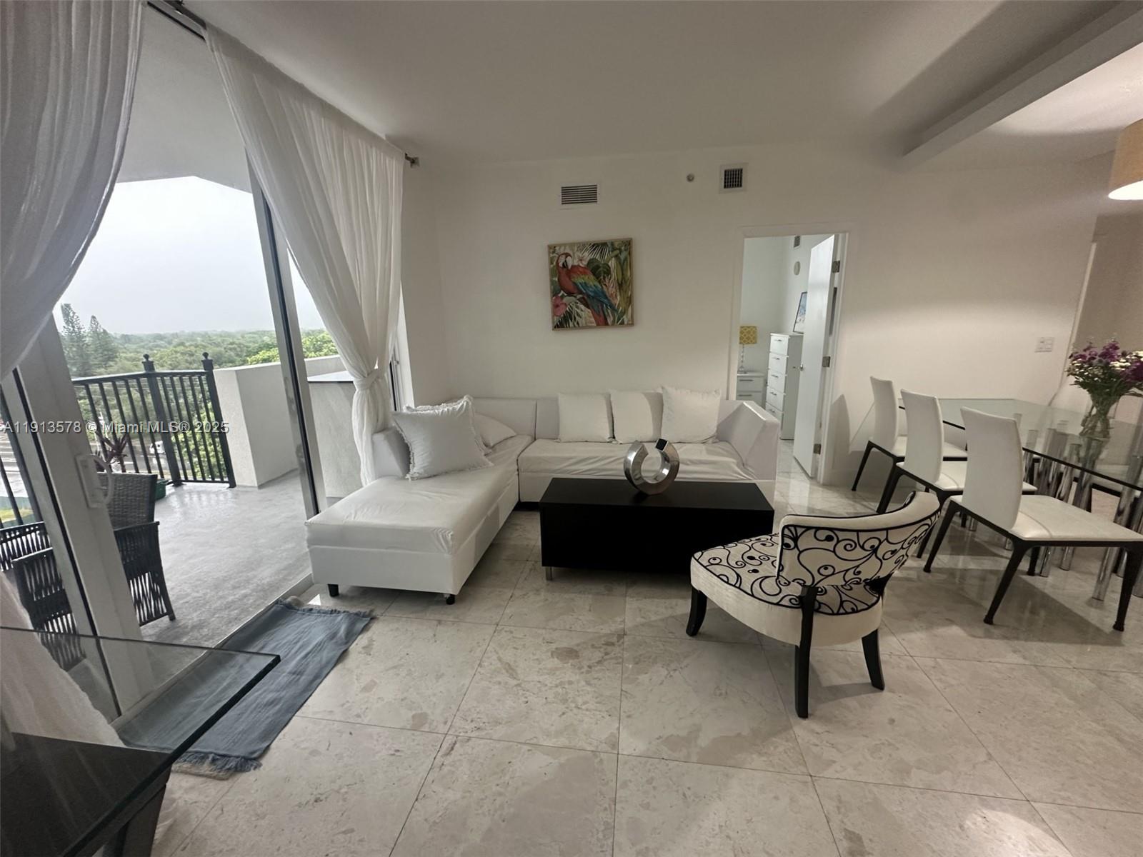 4100 Salzedo Street, Unit 704 Coral Gables, FL 33146 - Photo 16 of 25 a living room with furniture and a large window