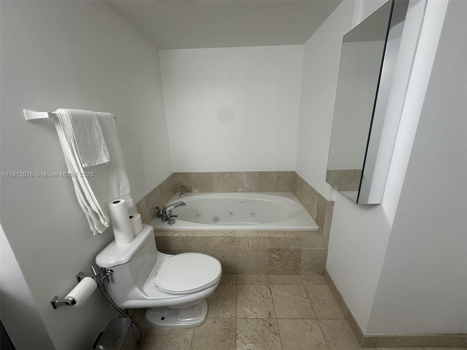 4100 Salzedo Street, Unit 704 Coral Gables, FL 33146 - Photo 17 of 25 a bathroom with a granite countertop toilet and a sink