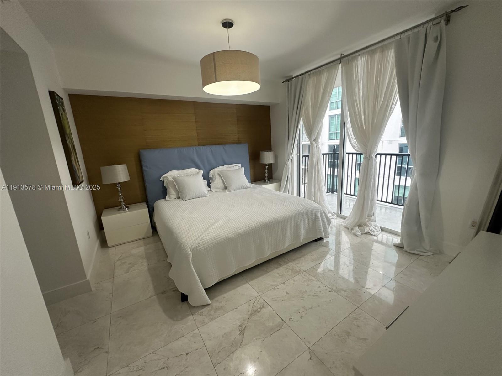 4100 Salzedo Street, Unit 704 Coral Gables, FL 33146 - Photo 21 of 25 a bedroom with a bed and a large window