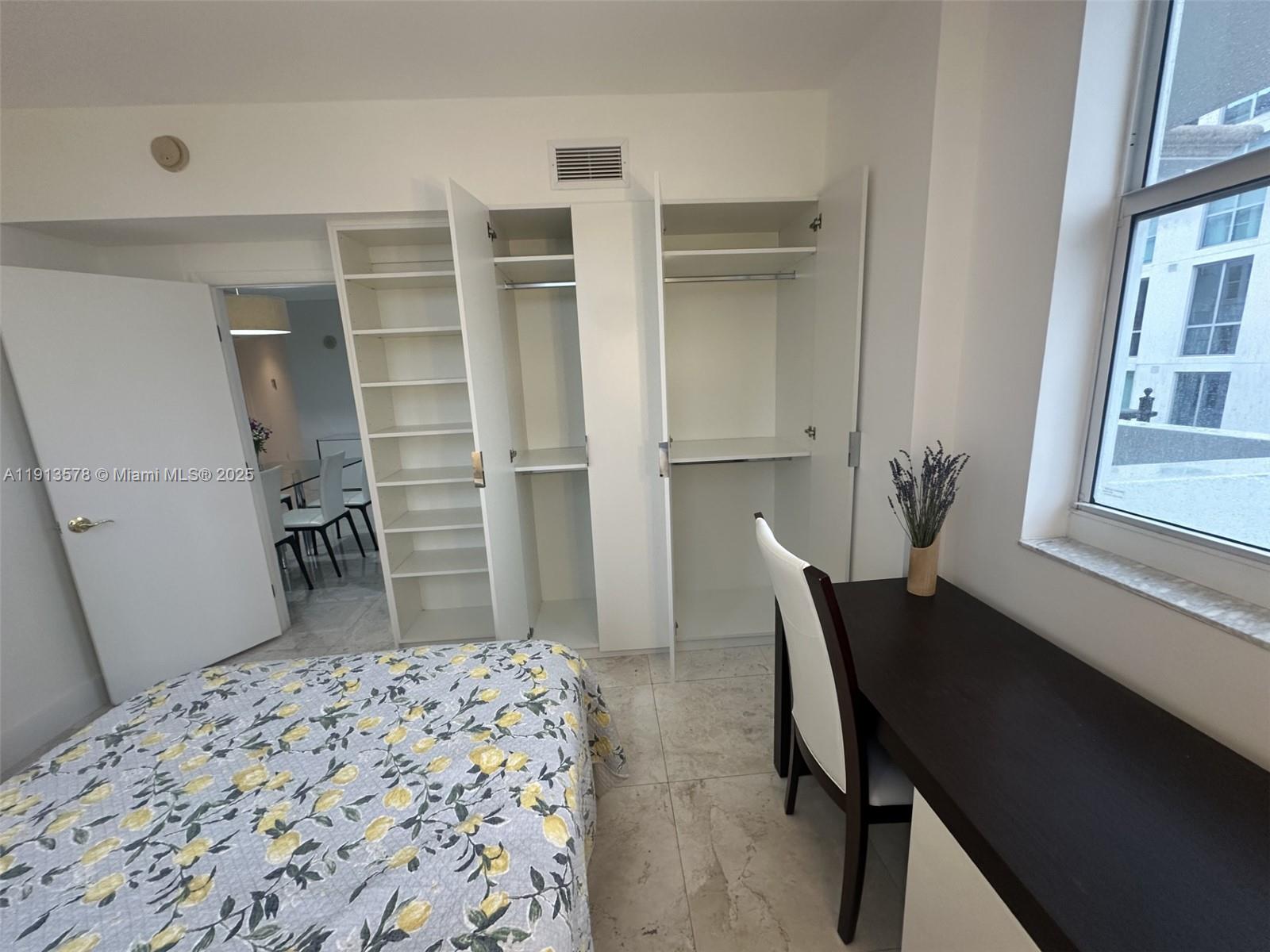 4100 Salzedo Street, Unit 704 Coral Gables, FL 33146 - Photo 7 of 25 a bedroom with a bed and a window