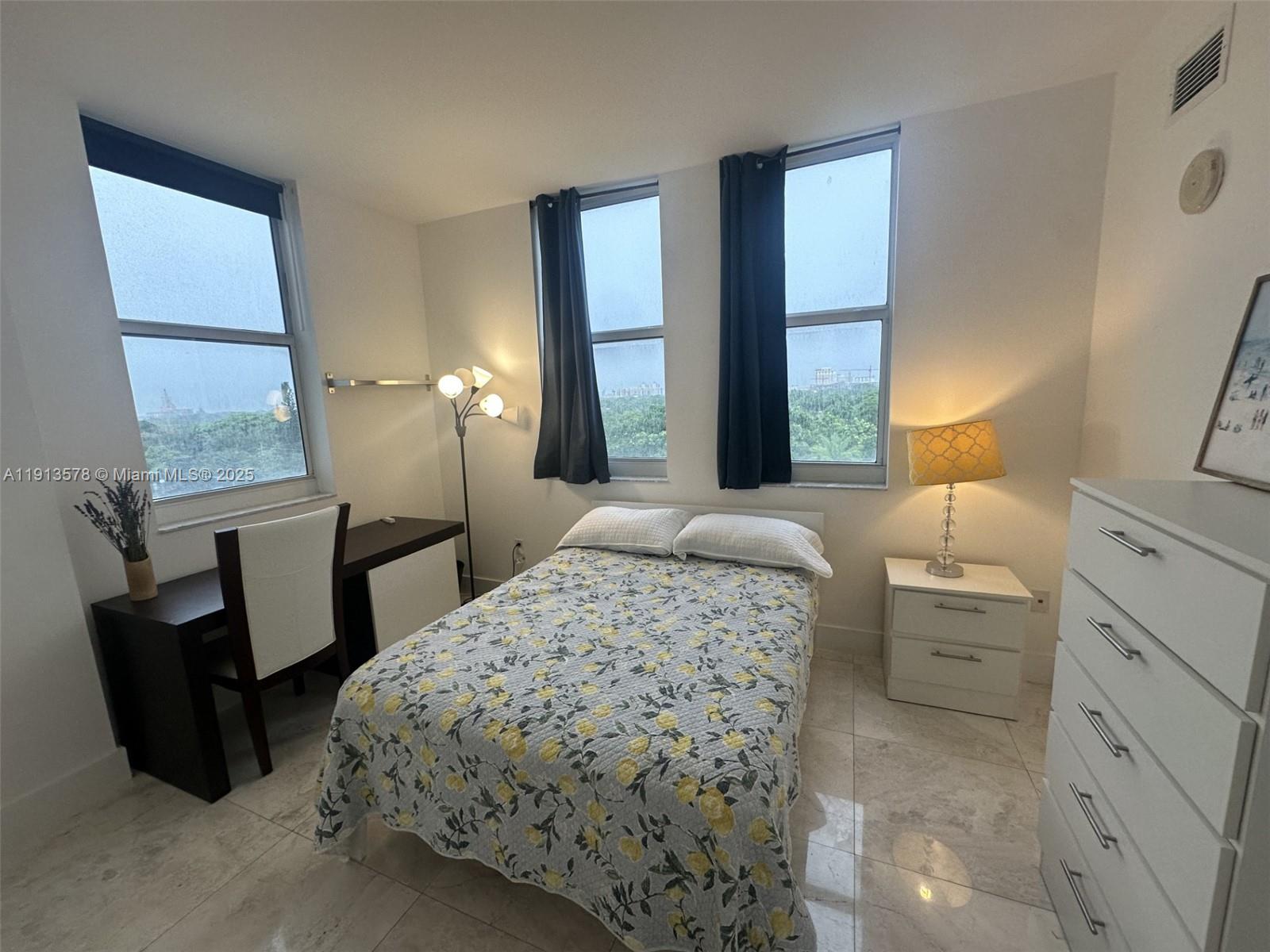 4100 Salzedo Street, Unit 704 Coral Gables, FL 33146 - Photo 8 of 25 a bedroom with a bed a couch and dresser