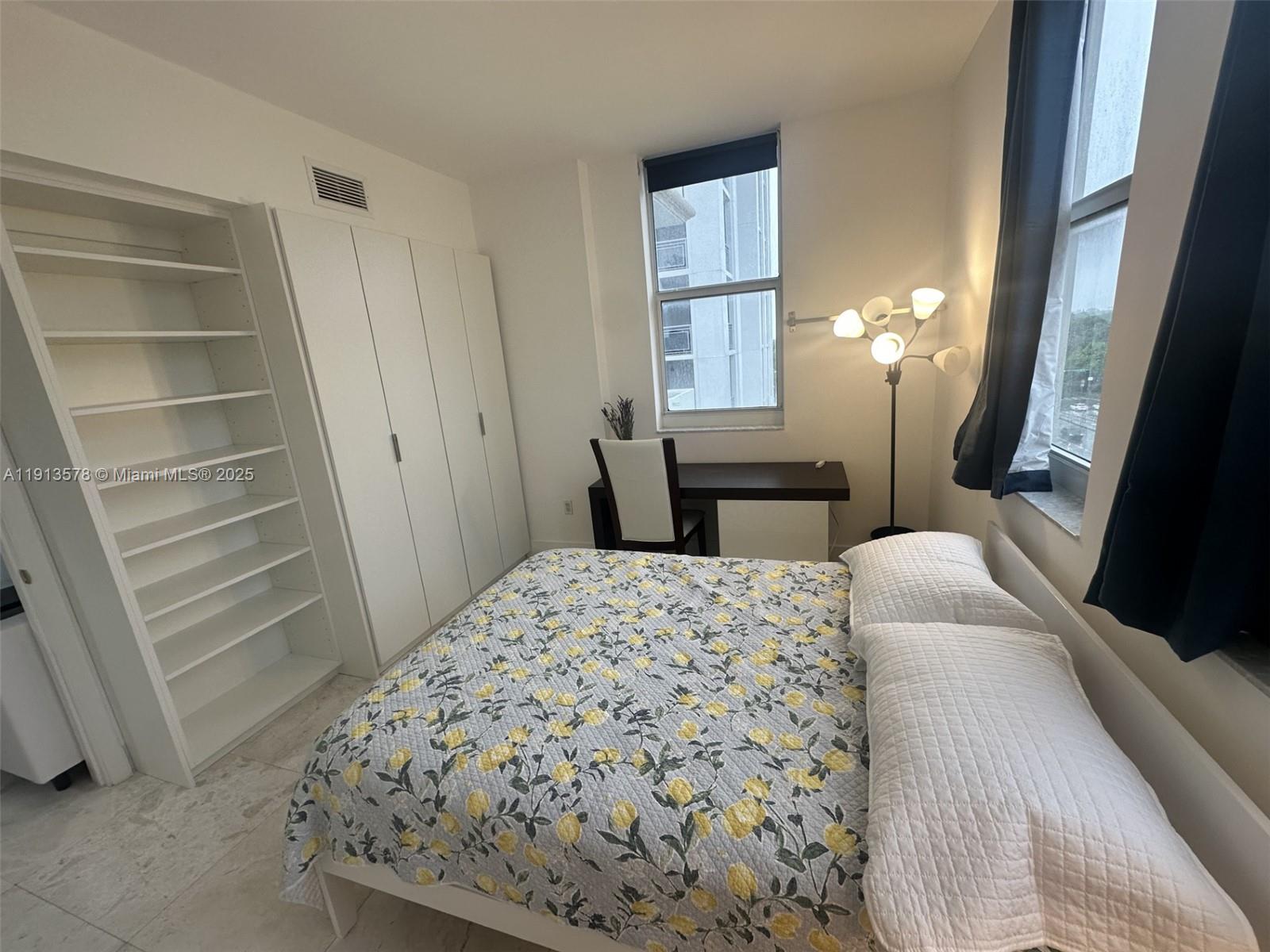 4100 Salzedo Street, Unit 704 Coral Gables, FL 33146 - Photo 9 of 25 a bedroom with a bed and a dresser with rug