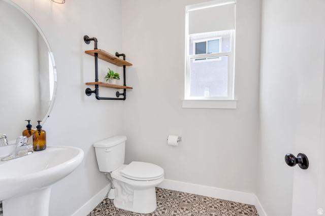 252 North Sunrise Rnch Drive Mapleton, UT 84664 - Photo 26 of 62 Powder room with a pedestal sink, white toilet, and patterned floor tiles