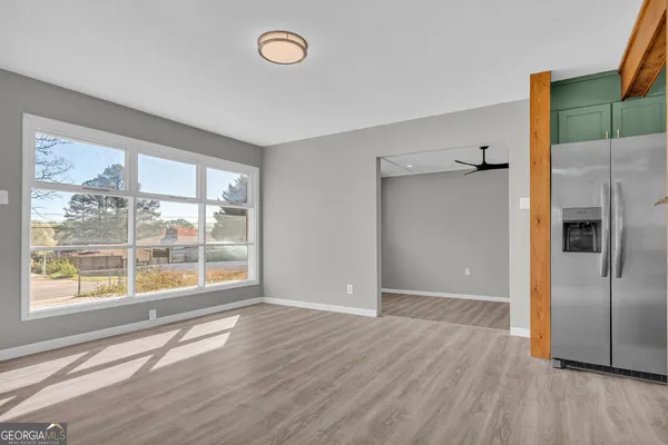 a view of a room with wooden floor and cabinet