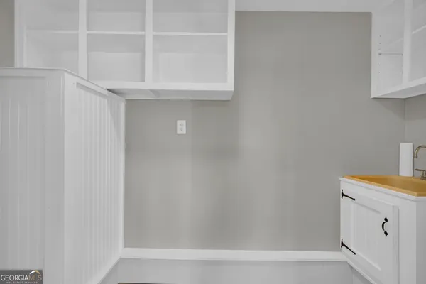 an empty room with wooden floor and a ceiling fan