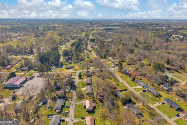 an aerial view of residential houses with outdoor space