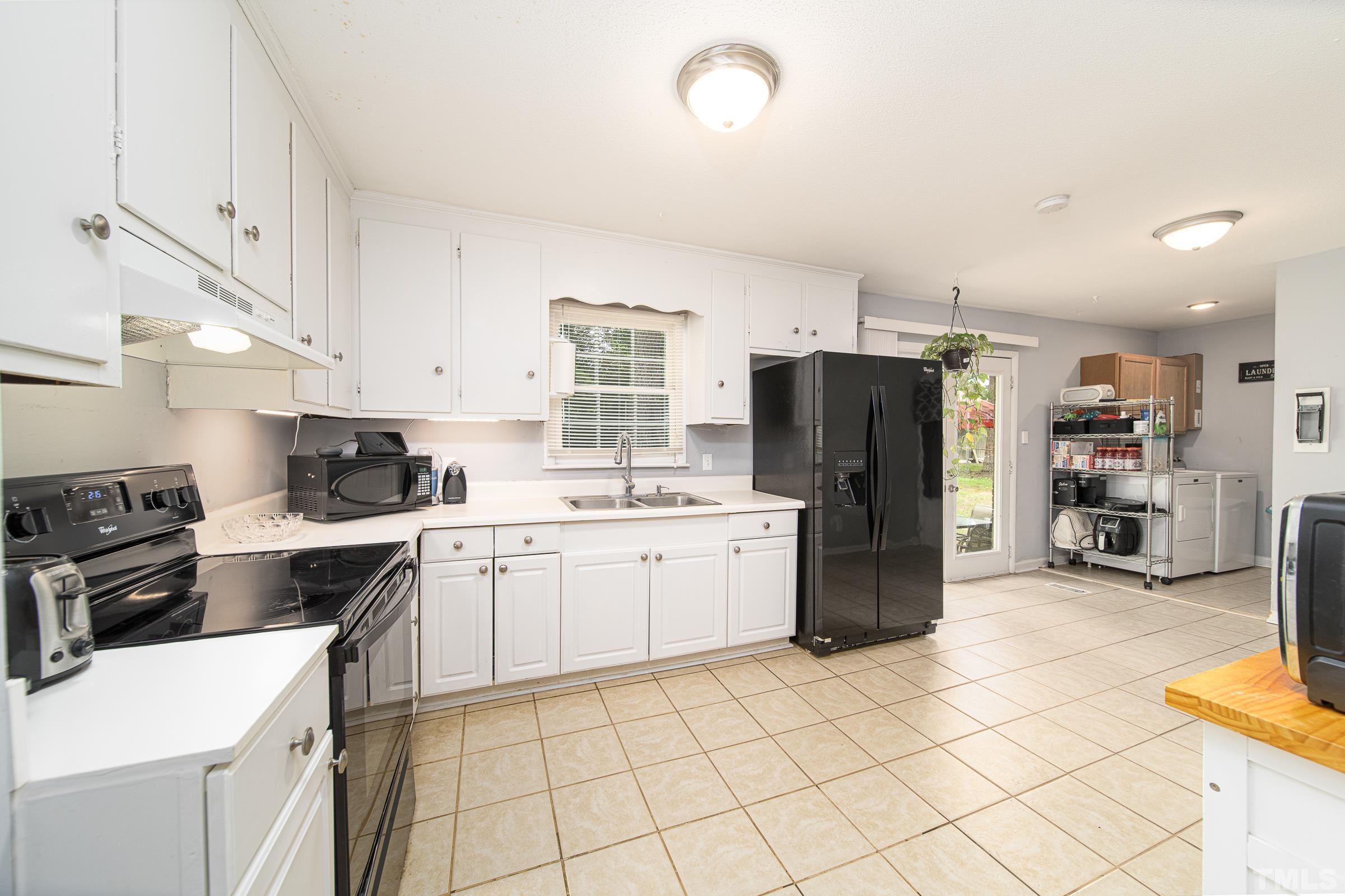 6325 Diamond Drive Raleigh, NC 27610 - Photo 15 of 25 a kitchen with a refrigerator and a stove top oven