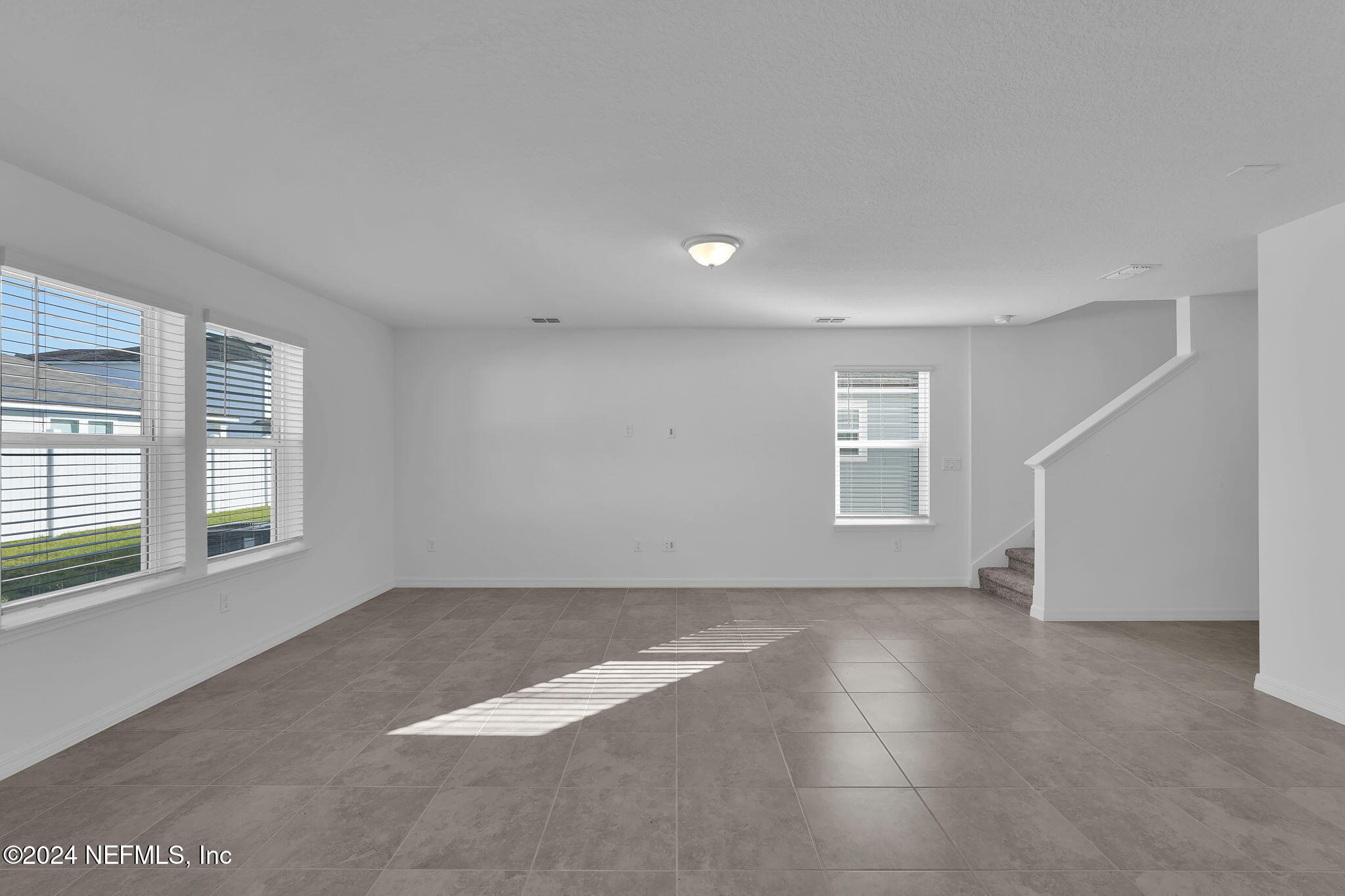 5441 Integrity Way Jacksonville, FL 32244 - Photo 11 of 38 an empty room with windows