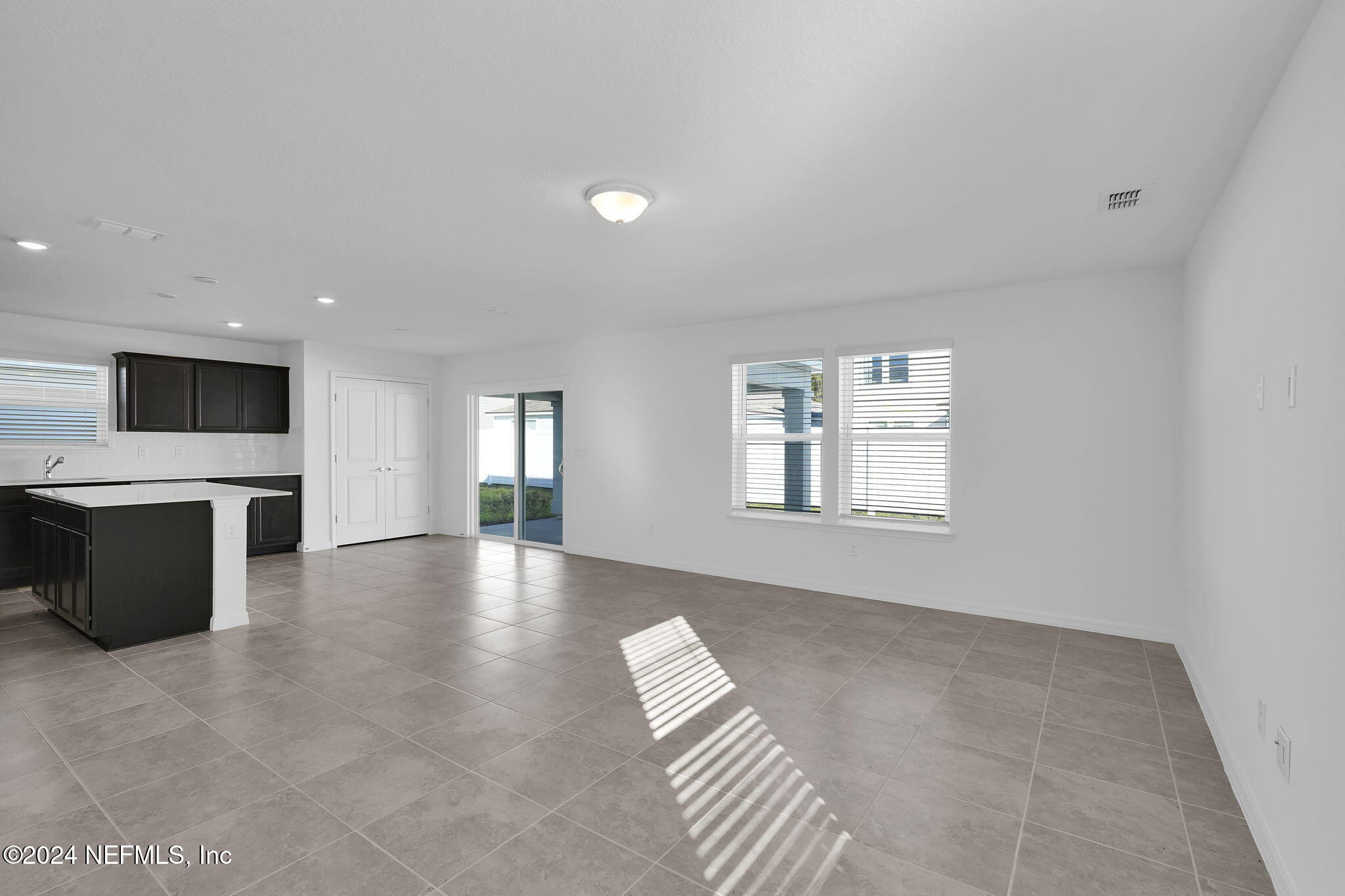 5441 Integrity Way Jacksonville, FL 32244 - Photo 13 of 38 a view of an empty room with a window and kitchen view