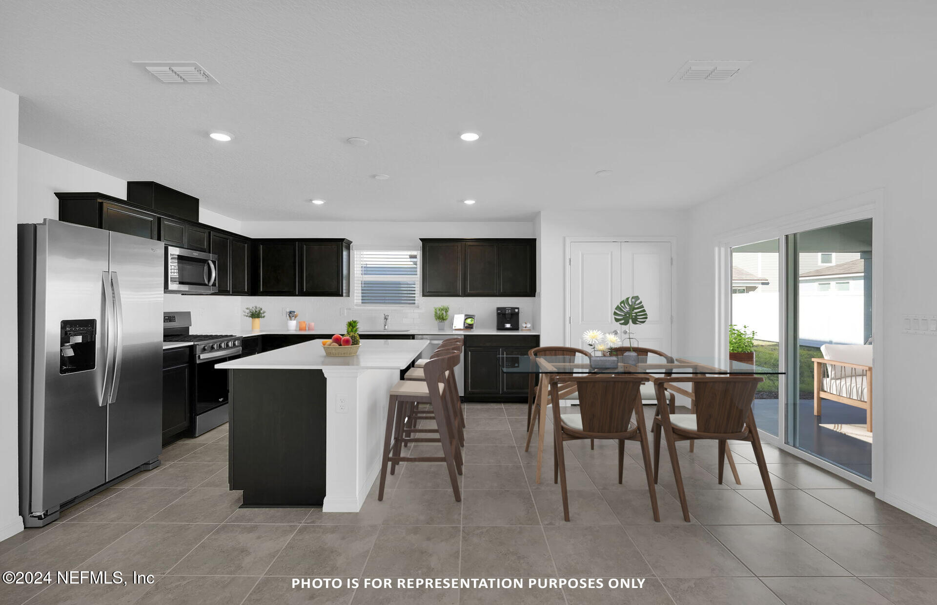 5441 Integrity Way Jacksonville, FL 32244 - Photo 16 of 38 a view of kitchen with refrigerator stove dining table and chairs