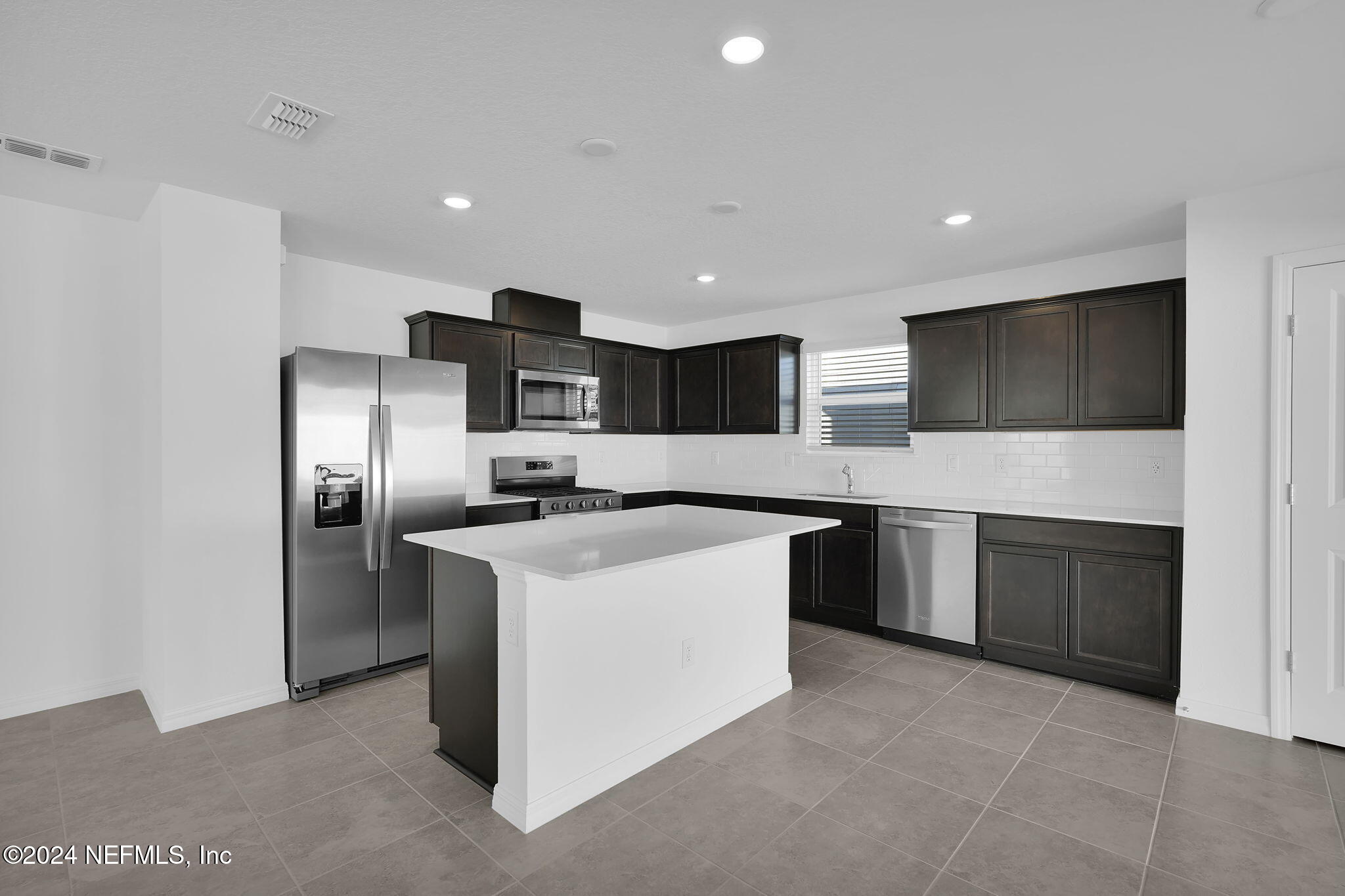 5441 Integrity Way Jacksonville, FL 32244 - Photo 17 of 38 a large kitchen with a large counter top appliances and cabinets