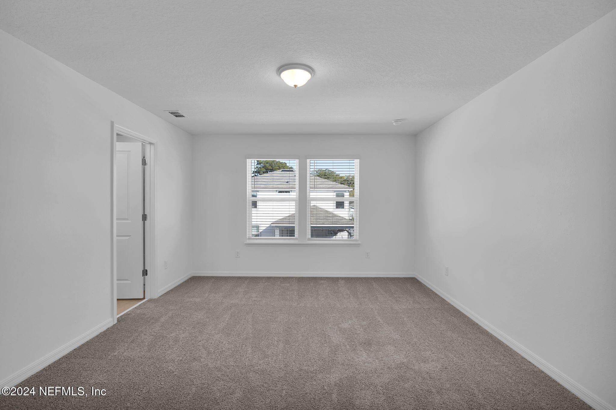 5441 Integrity Way Jacksonville, FL 32244 - Photo 24 of 38 an empty room with windows