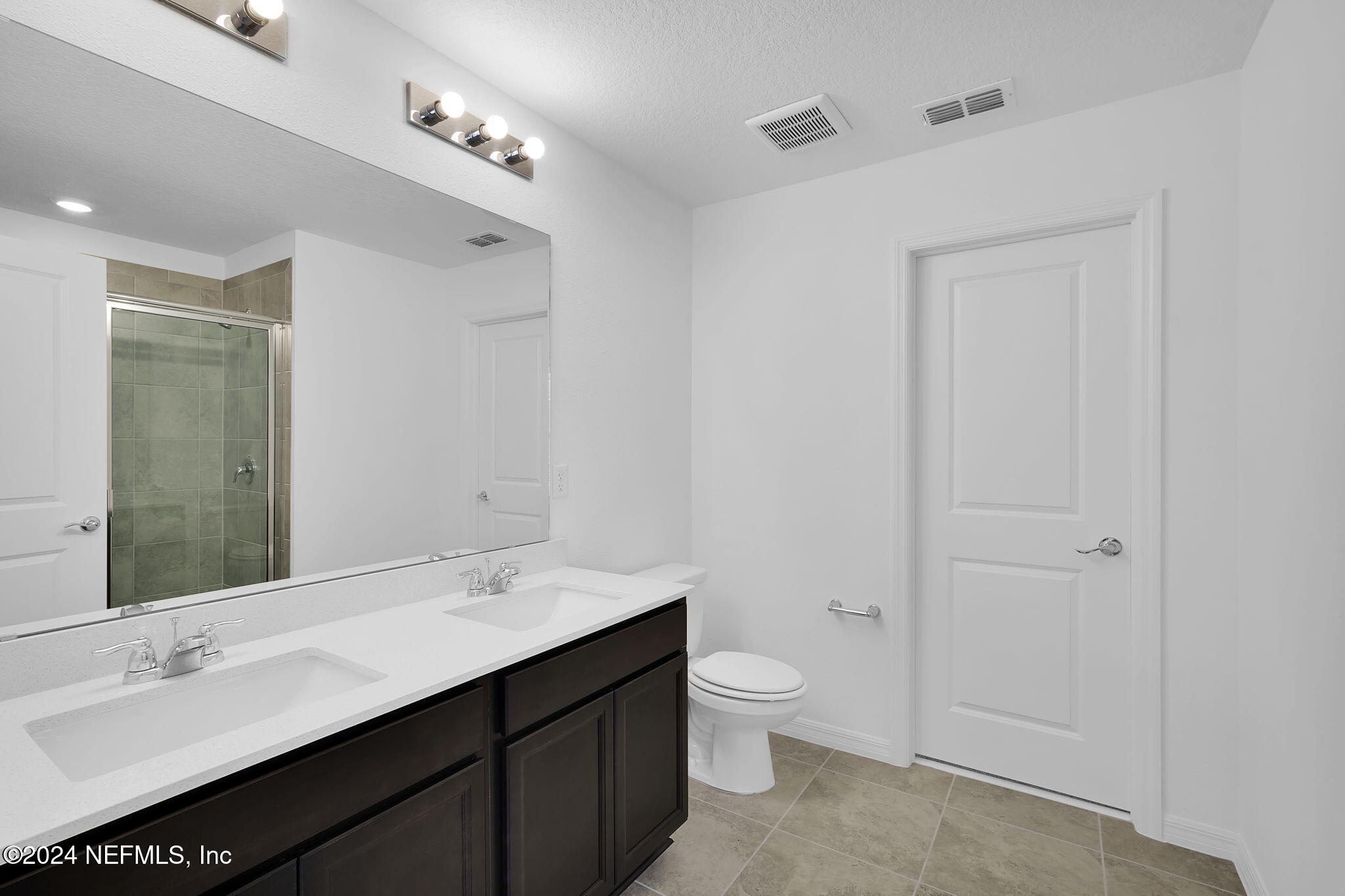 5441 Integrity Way Jacksonville, FL 32244 - Photo 26 of 38 a bathroom with a double vanity sink toilet and a mirror