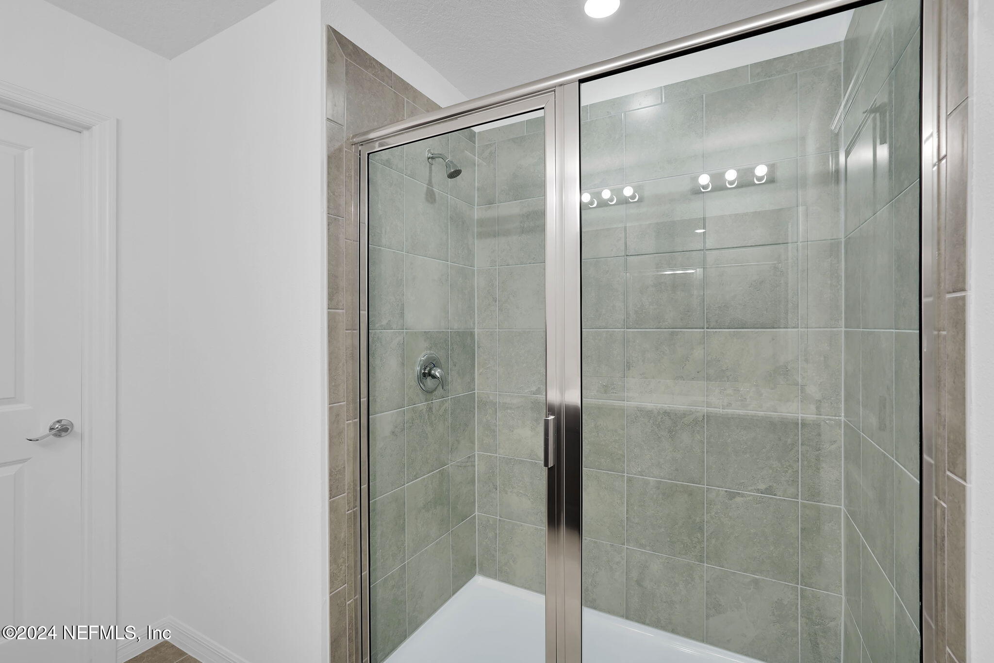 5441 Integrity Way Jacksonville, FL 32244 - Photo 27 of 38 a bathroom with a glass shower door