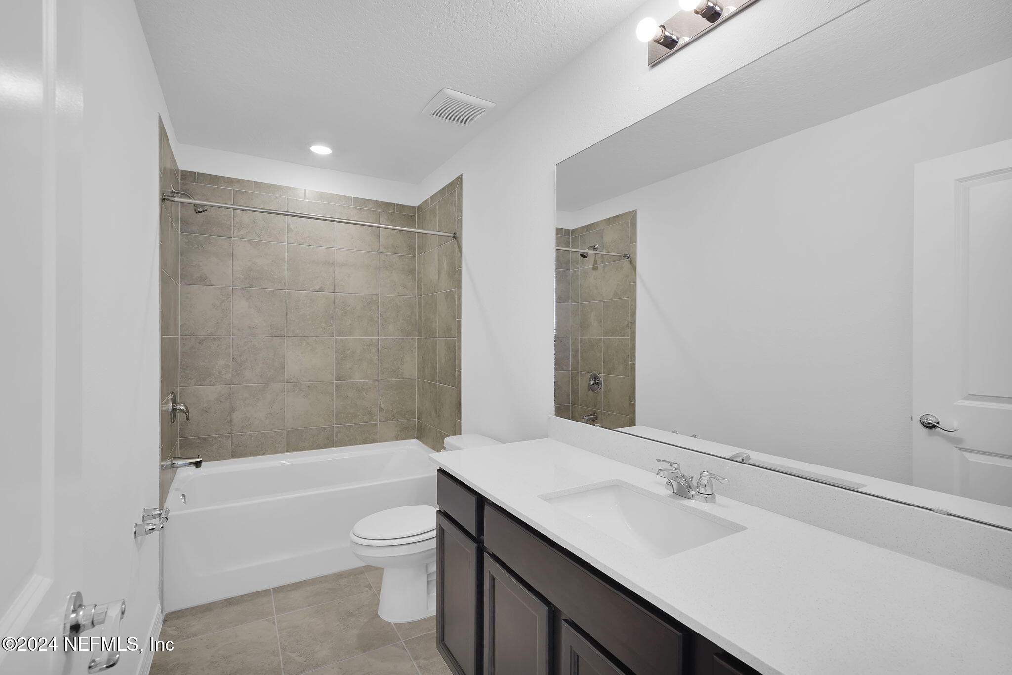 5441 Integrity Way Jacksonville, FL 32244 - Photo 30 of 38 a bathroom with a bathtub shower sink vanity and toilet