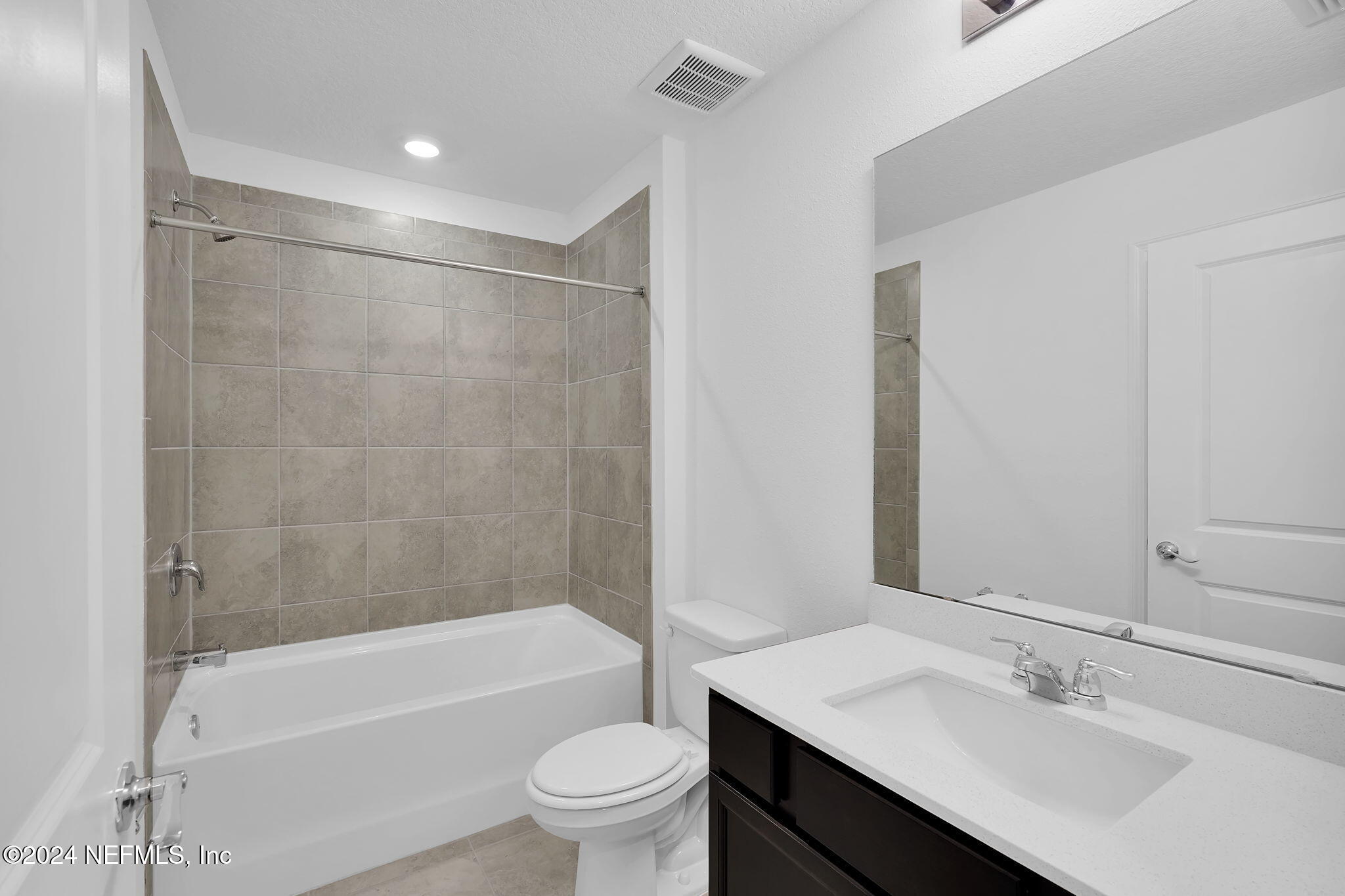 5441 Integrity Way Jacksonville, FL 32244 - Photo 32 of 38 a bathroom with a sink mirror toilet and bathtub