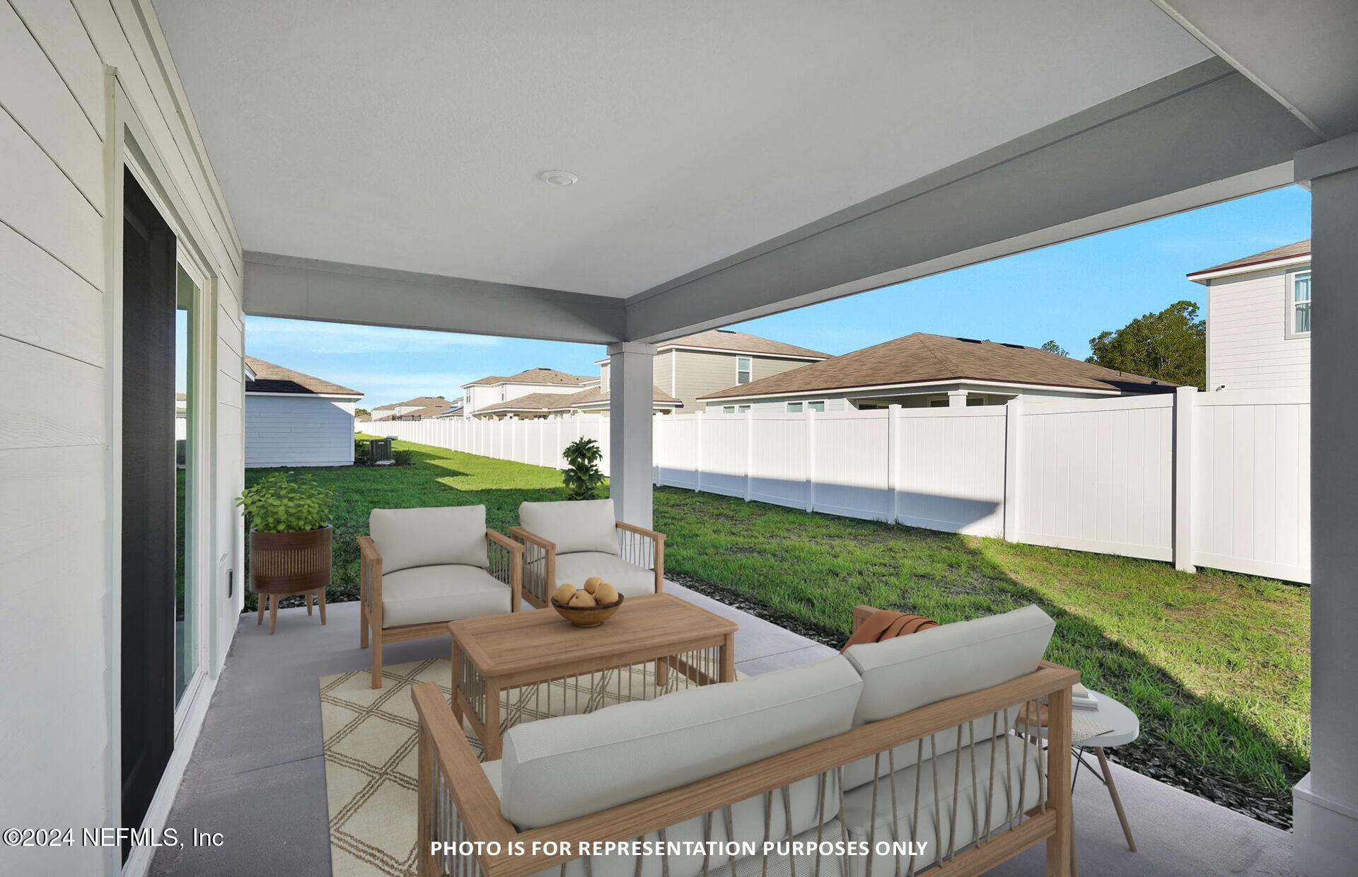 5441 Integrity Way Jacksonville, FL 32244 - Photo 36 of 38 a living room with patio furniture and a garden