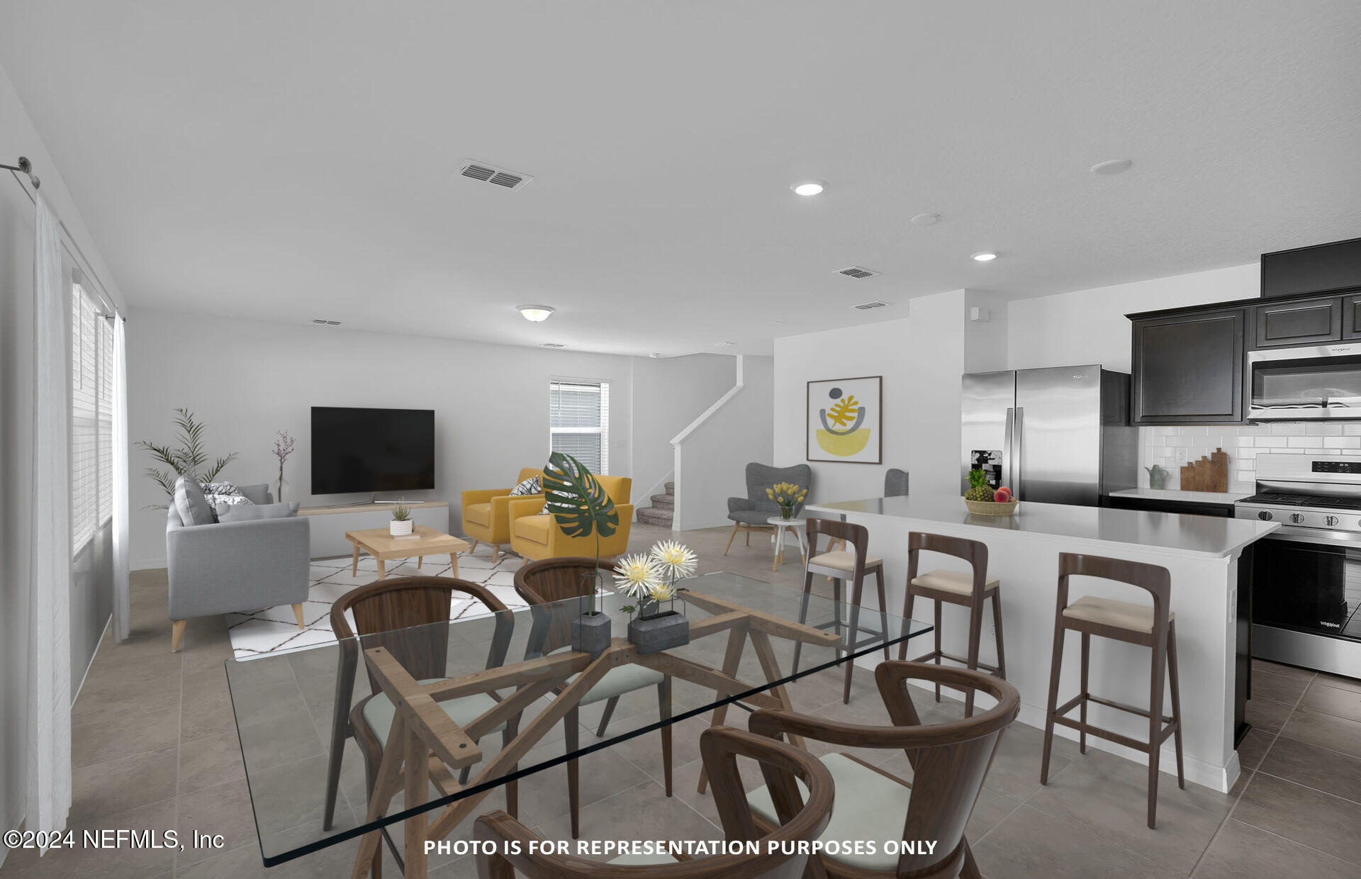 5441 Integrity Way Jacksonville, FL 32244 - Photo 8 of 38 a living room with furniture a flat screen tv and kitchen view