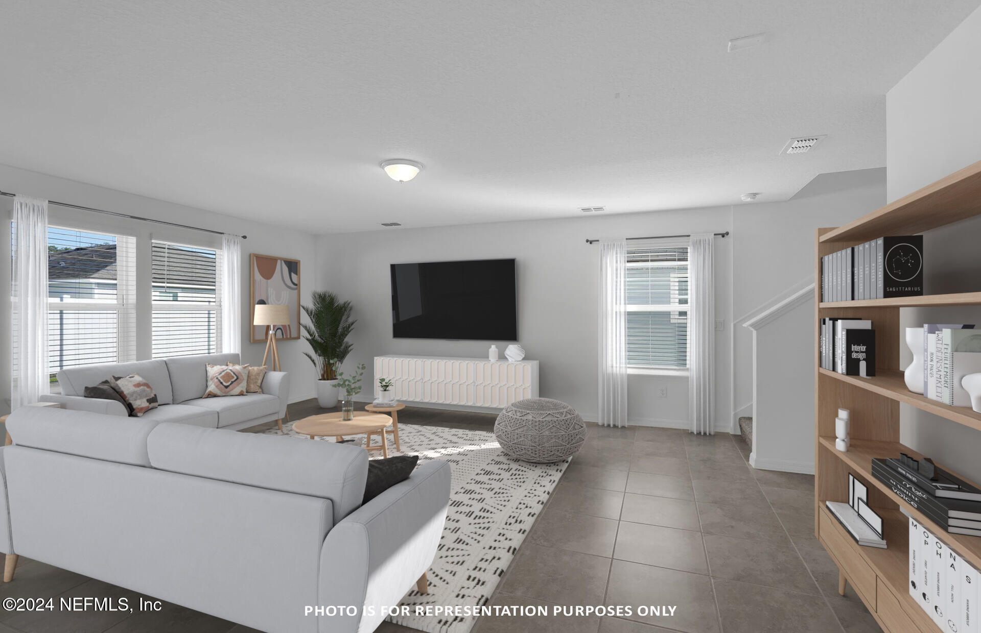 5441 Integrity Way Jacksonville, FL 32244 - Photo 10 of 38 a living room with furniture and a flat screen tv