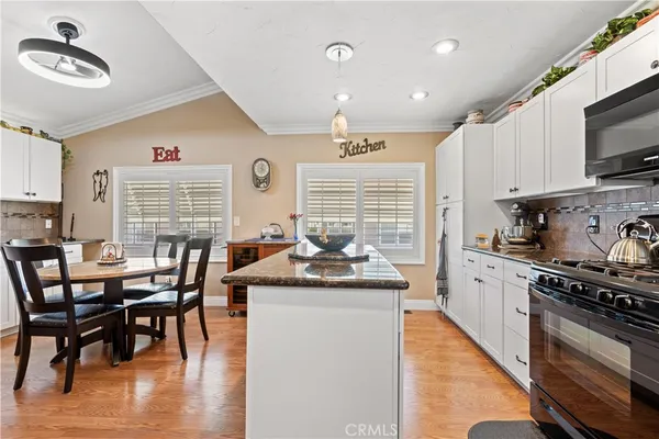 a living room with furniture a dining table and wooden floor